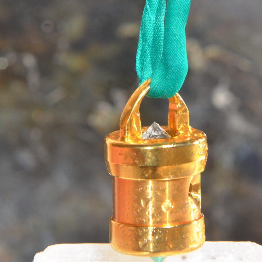 Prana Solaris heart-coherence pendant in titanium-gold